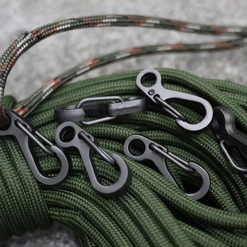 Green rope with metal carabiners on a gray background