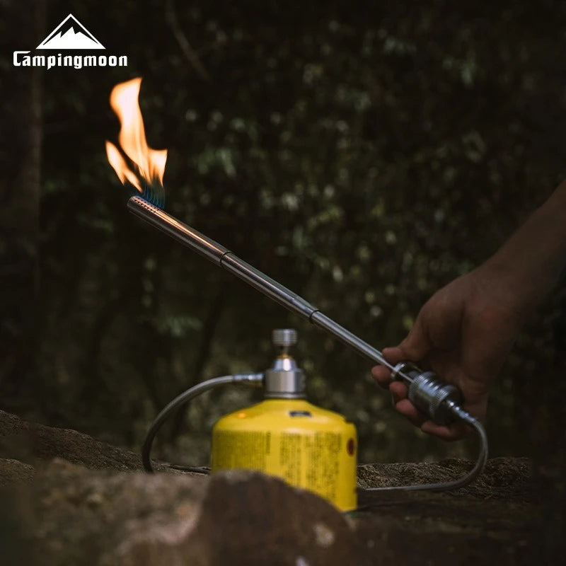 Campingmoon gas torch being used outdoors with a blurred natural background
