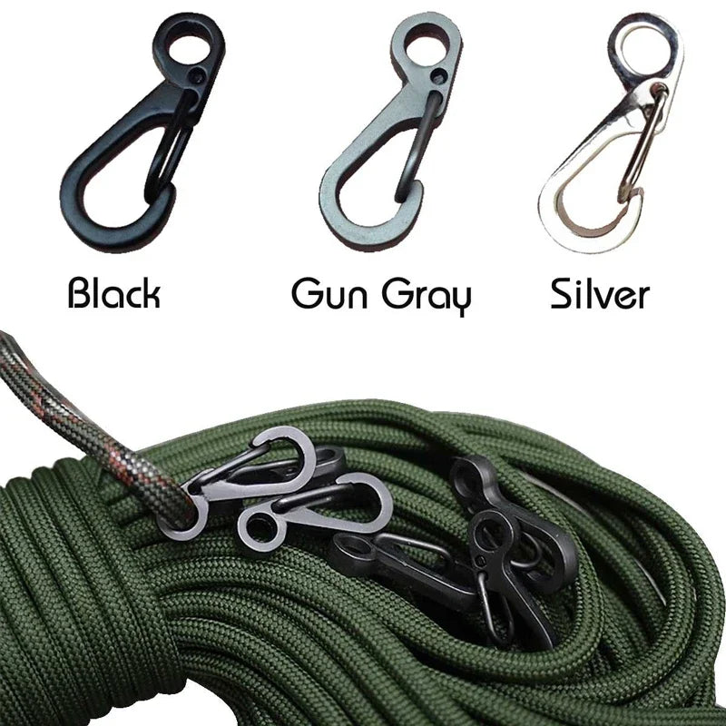 Three carabiners in black, gun gray, and silver with a green rope.