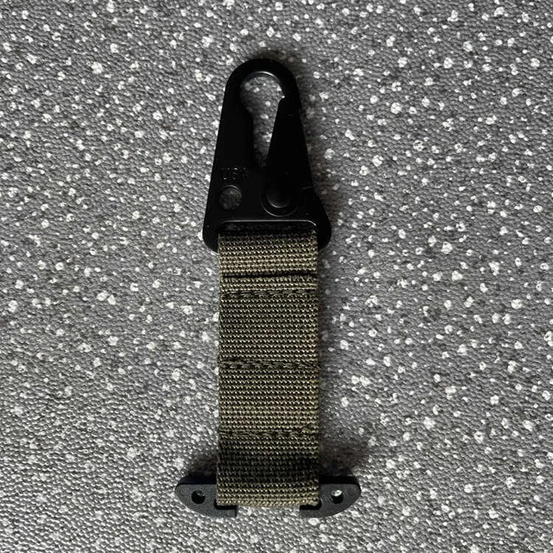 Black carabiner with a woven strap on a textured gray background
