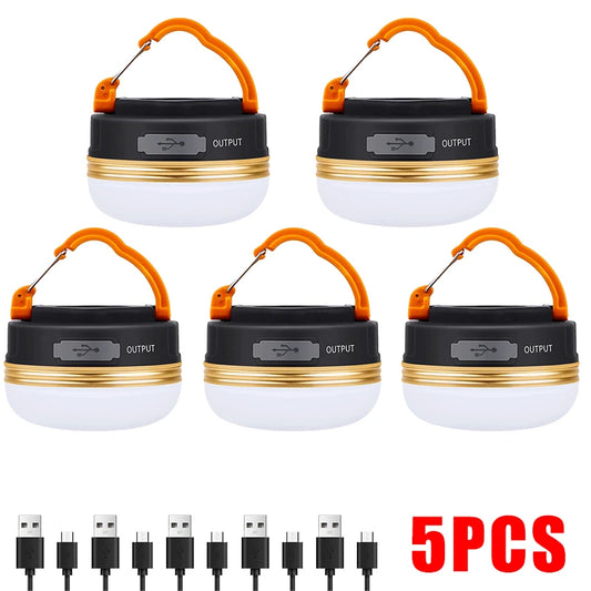 Set of five camping lanterns with USB charging cables on a white background
