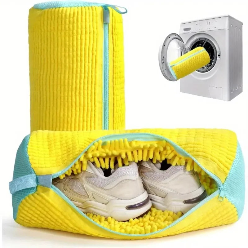 Yellow shoe bag with a blue zipper containing white sneakers, shown with a dryer in the corner.
