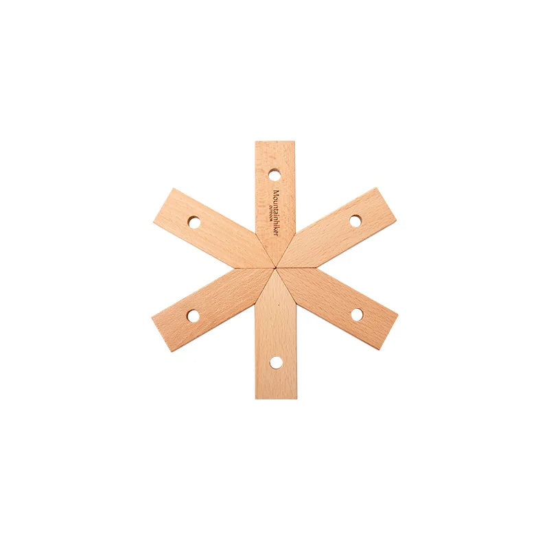 Wooden star-shaped object with holes on a white background