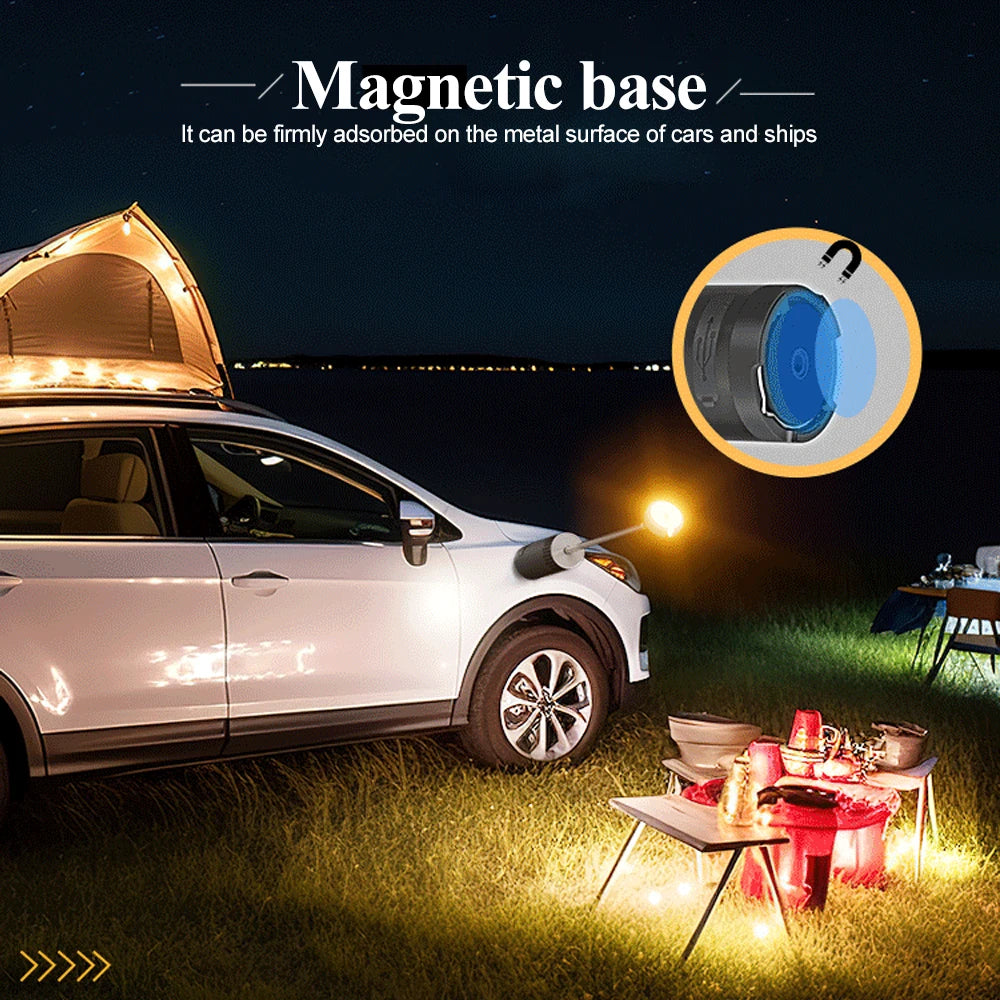Car with a magnetic base attachment in a camping setting at night.