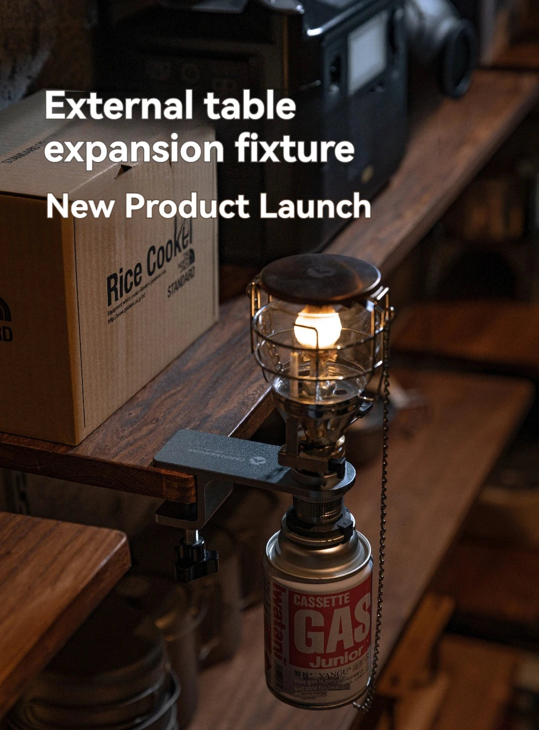 Gas lantern on a wooden table with text about an external table expansion fixture and new product launch.