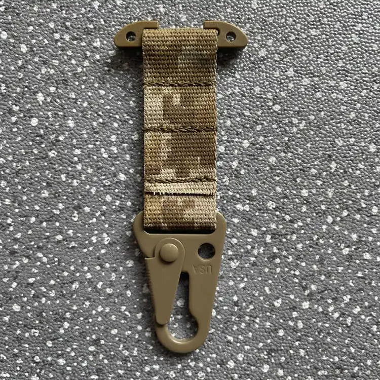 Tactical keychain with camouflage strap on a gray background