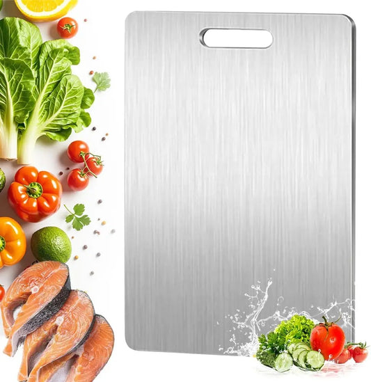 Stainless steel cutting board with vegetables and salmon on a white background