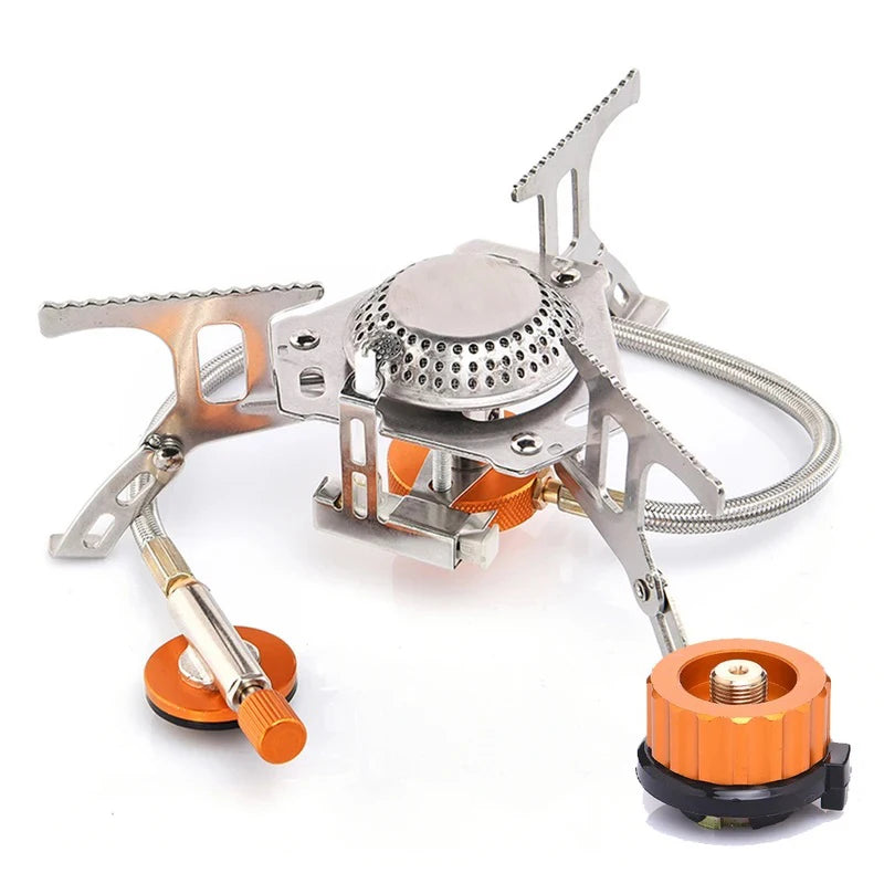 Portable camping stove with orange accents on a white background