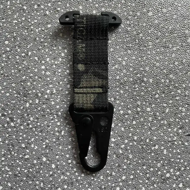 Black strap with clip on a gray textured background