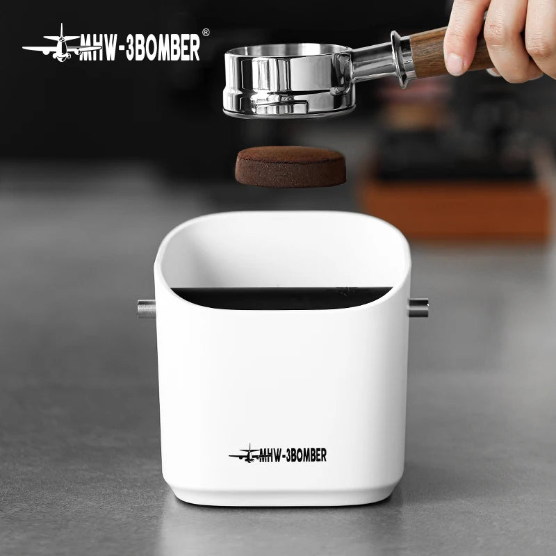 White coffee grinder with a hand holding a coffee bean above it, branded 'MHW-3BOMBER'.