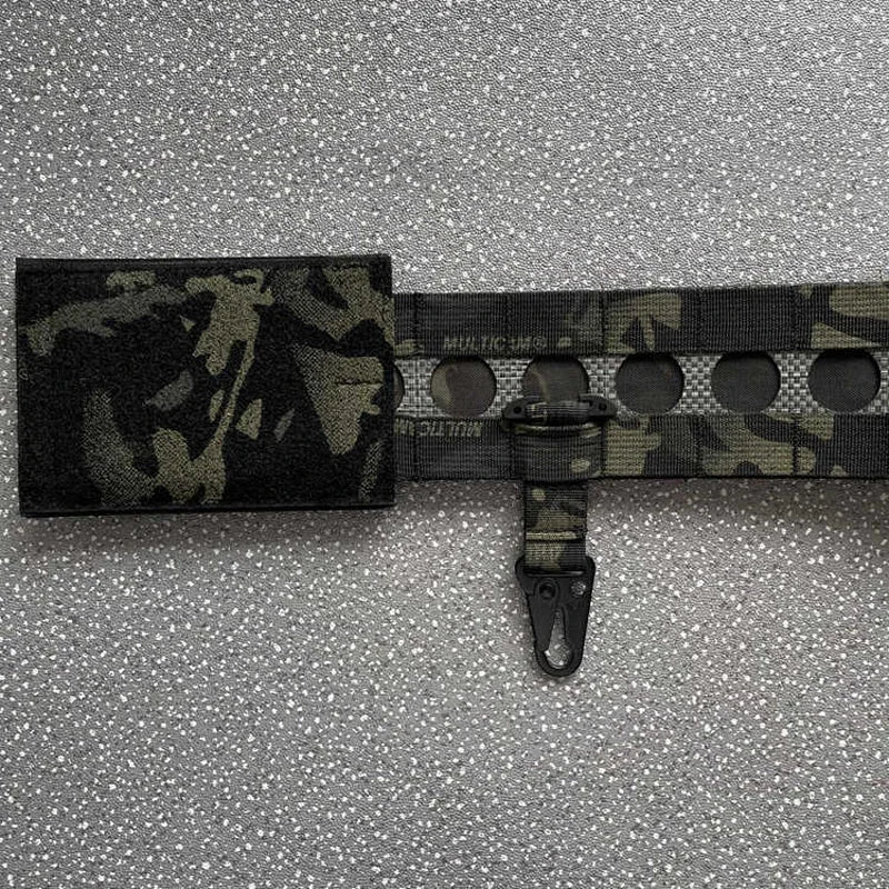 Camouflage belt with a buckle on a gray textured background