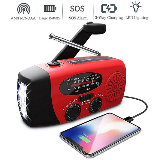 Red and black portable radio with phone charging cable on a white background