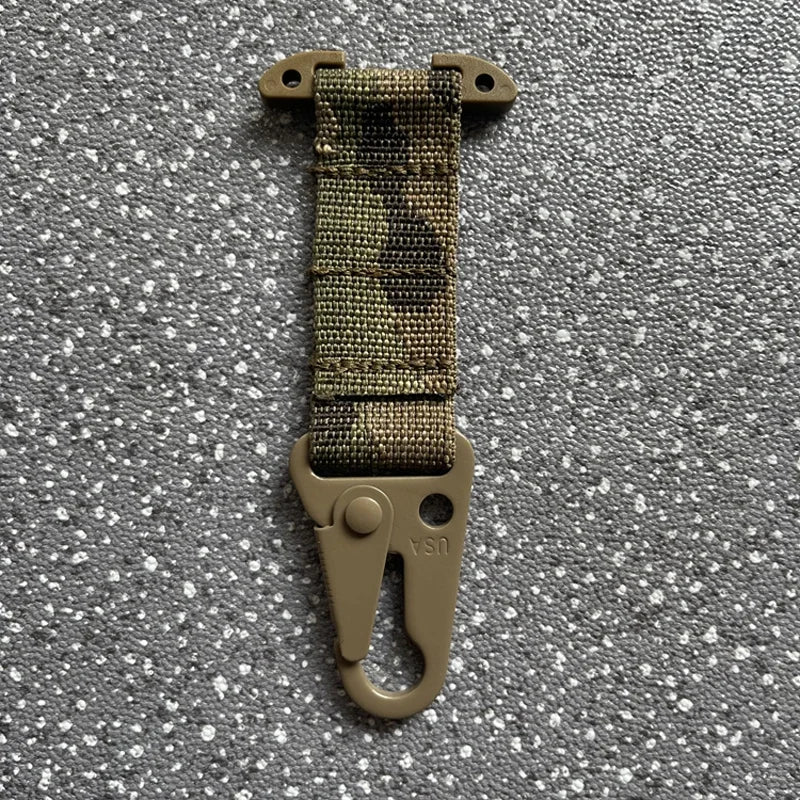 Camouflage strap with a metal clip on a gray textured background